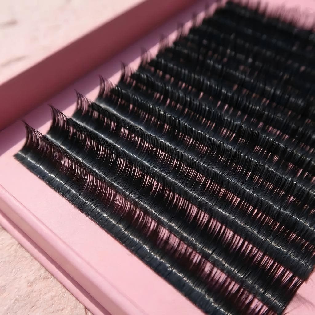 Close-up of Lashmaitre Easy Fans easy fan volume lash extensions showing black PBT fibers and clean pickup from the strip for wholesale supply