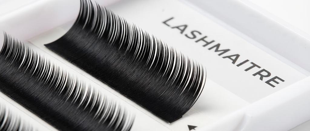 Extreme close-up macro photography showing the consistent curl and fine taper of premium PBT lash fibers, representing the high quality of LASHMAITRE wholesale eyelash extensions in Santa Barbara.