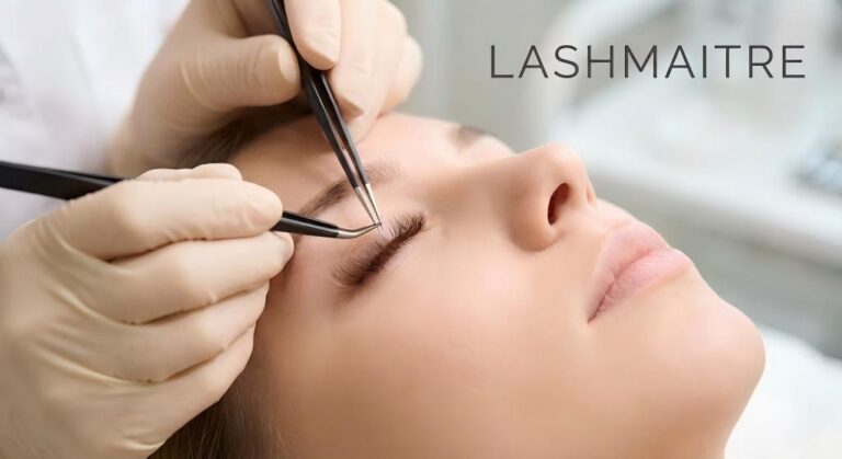 Professional lash artist applying LASHMAITRE brown eyelash extensions to a client, demonstrating the soft, natural alternative to traditional black lashes.