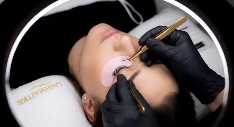 Close-up of a LASHMAITRE artist using gold tweezers to demonstrate the precision of high-margin volume lash kits used for eyelash extensions Burlington salons to increase profitability.