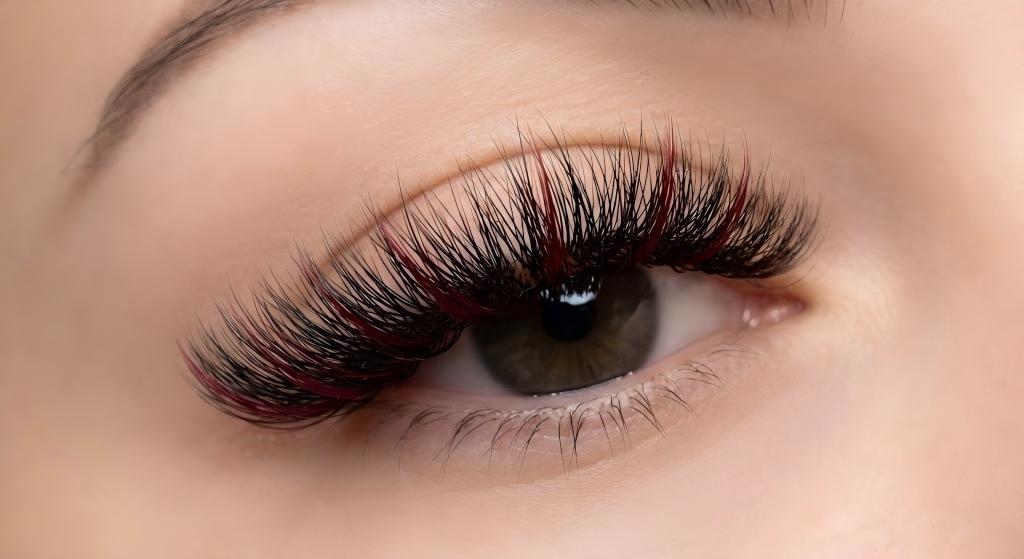 A close-up of a volume lash set featuring subtle "Razorback Red" accents, showcasing custom game day styling for eyelash extensions in Fayetteville AR fans and students.