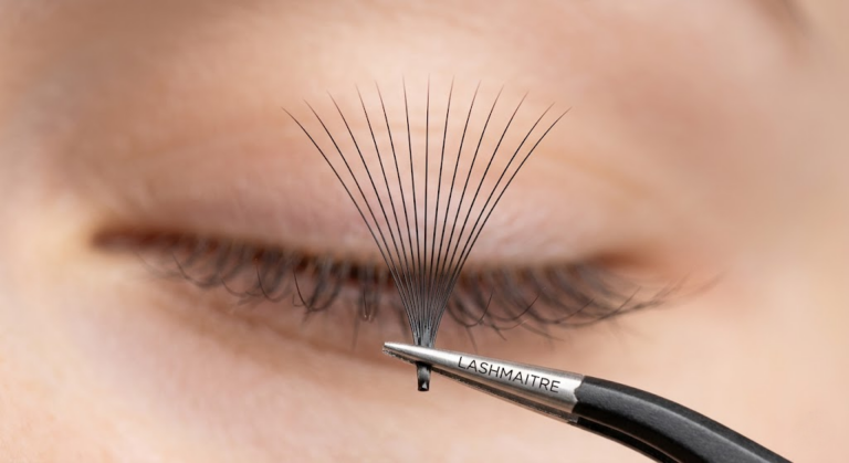 Extreme macro of a 15D LASHMAITRE 0.03mm synthetic fiber fan for volume cat eye eyelash extensions featuring a weightless base to prevent lash drooping.
